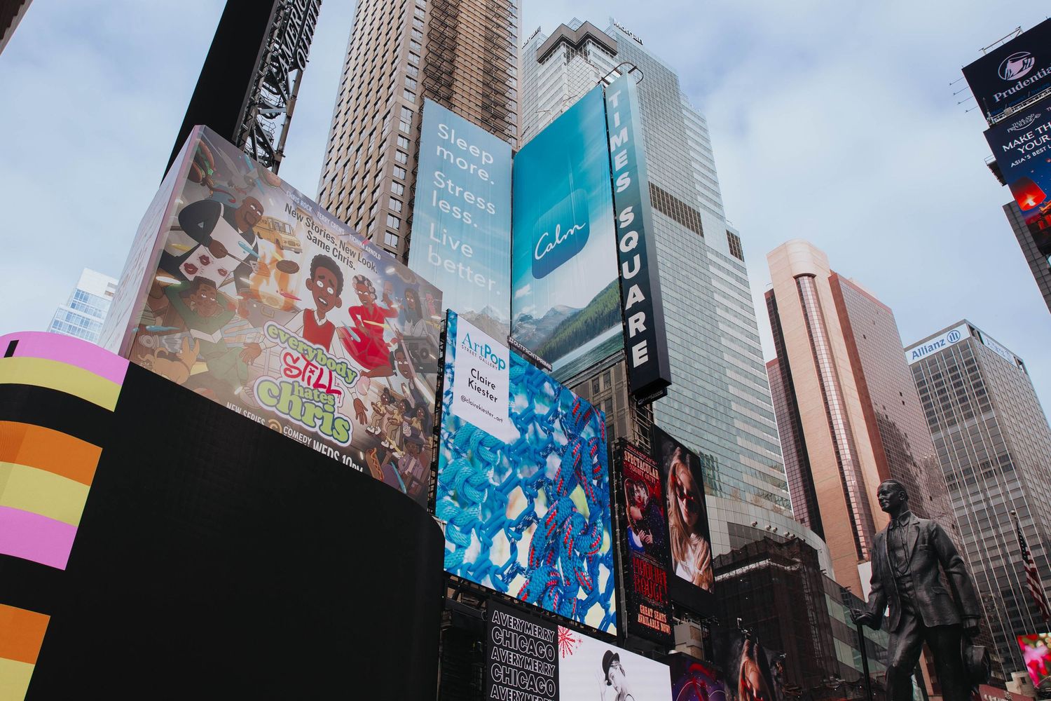 Urban cityscape with tall buildings and digital billboards.