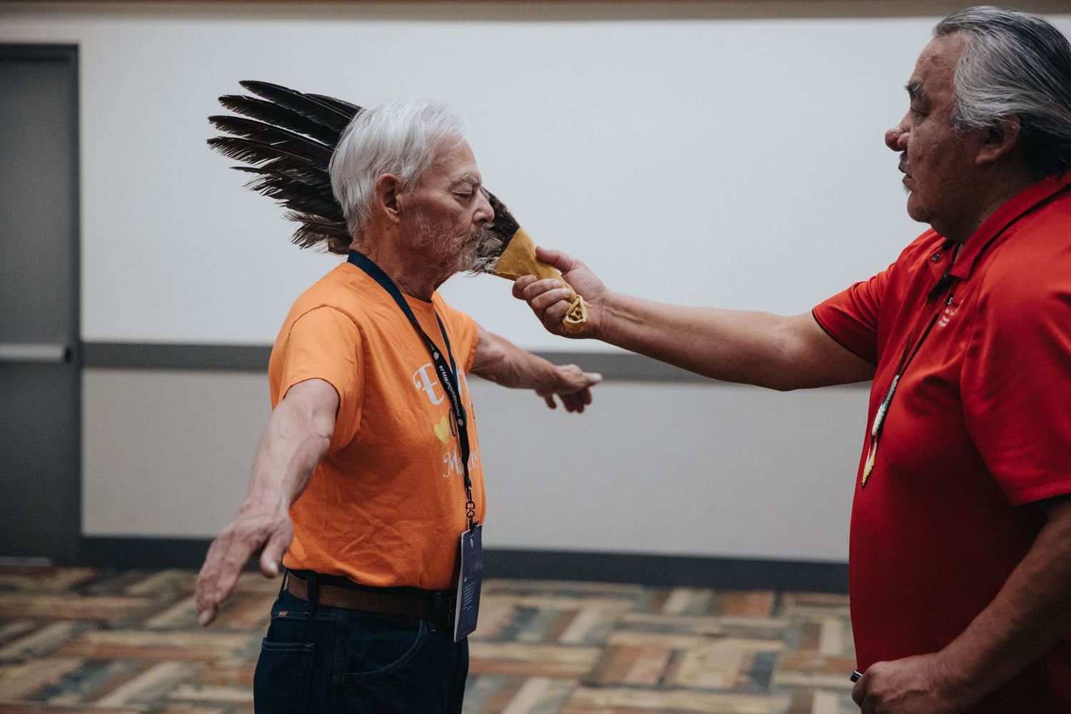 Two attendees share snacks during a conference networking break.