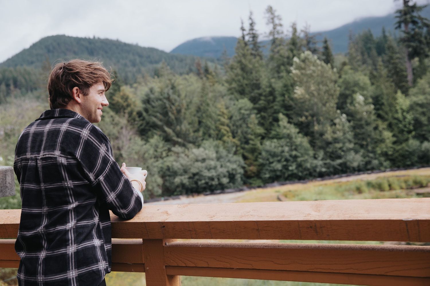Scenic mountain views from resort balcony with evergreen forests in the distance.