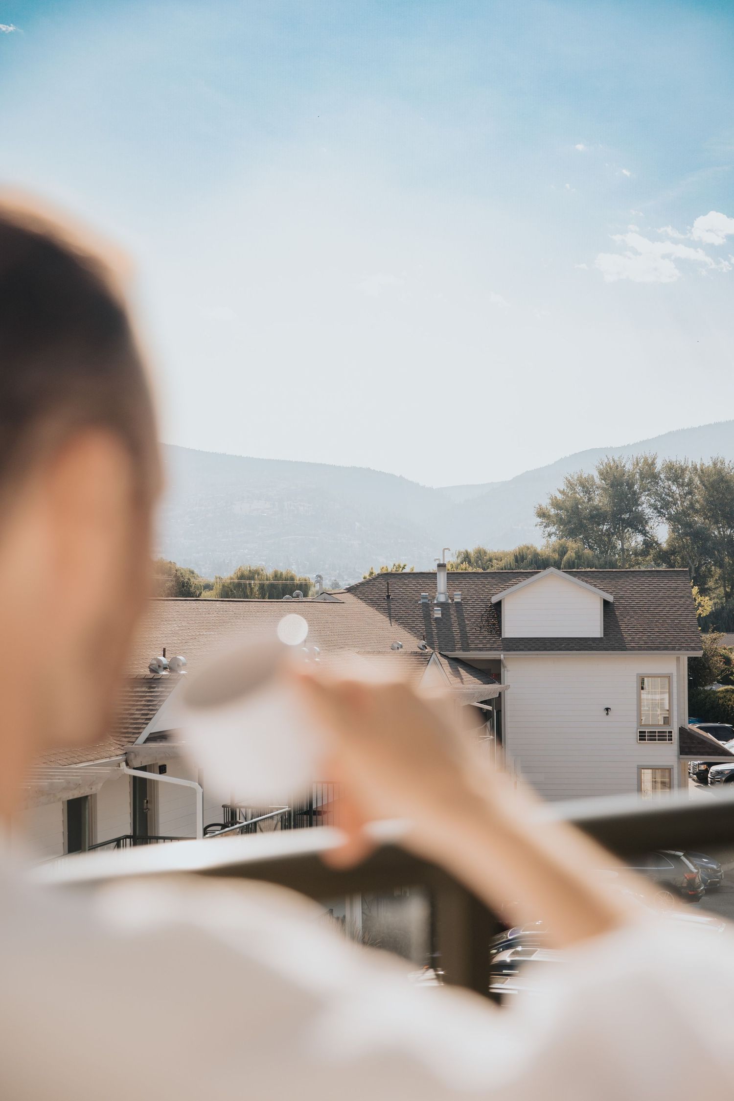 Scenic mountain view from apartment balcony on a sunny day.