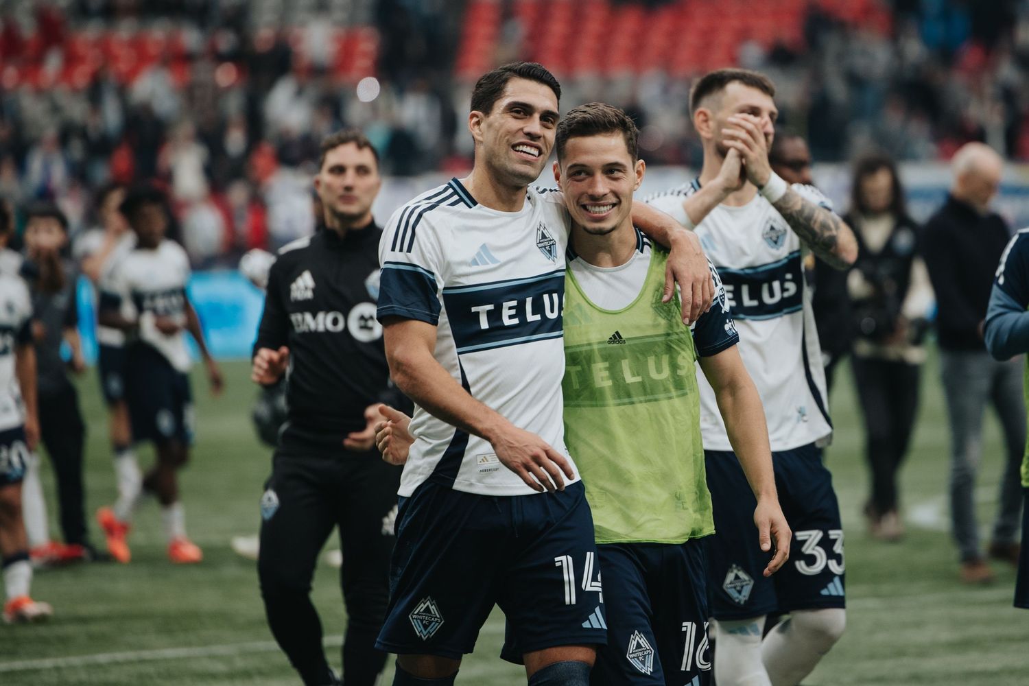 Team members celebrate together on the field after a successful play.