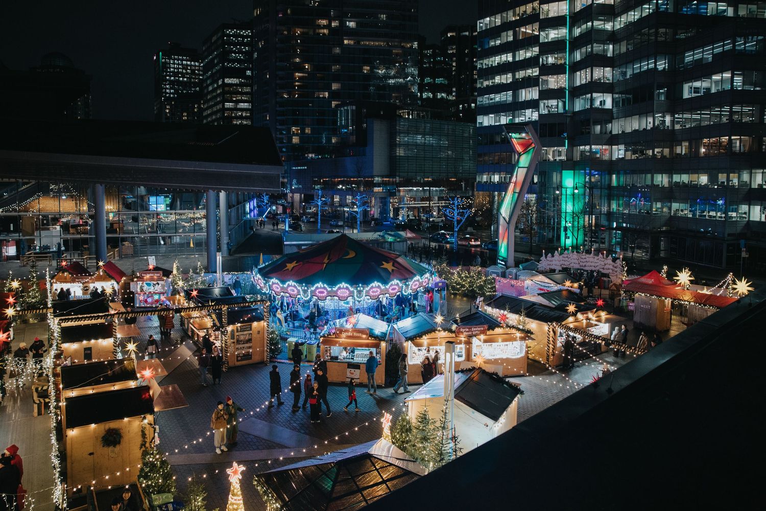 Nighttime cityscape with colorful lights and illuminated buildings creating a vibrant urban atmosphere.