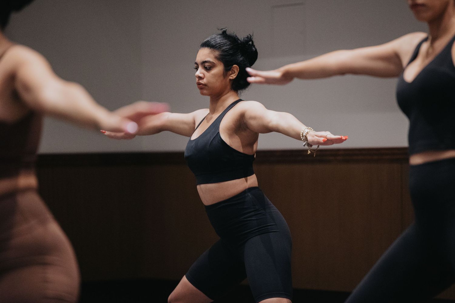 Fitness enthusiasts performing synchronized movements during an exercise class.