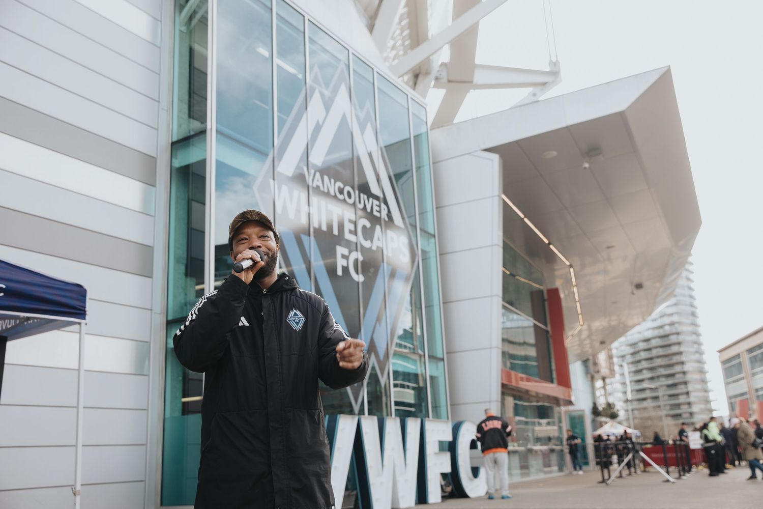 Professional gamers arriving at a modern esports arena entrance.