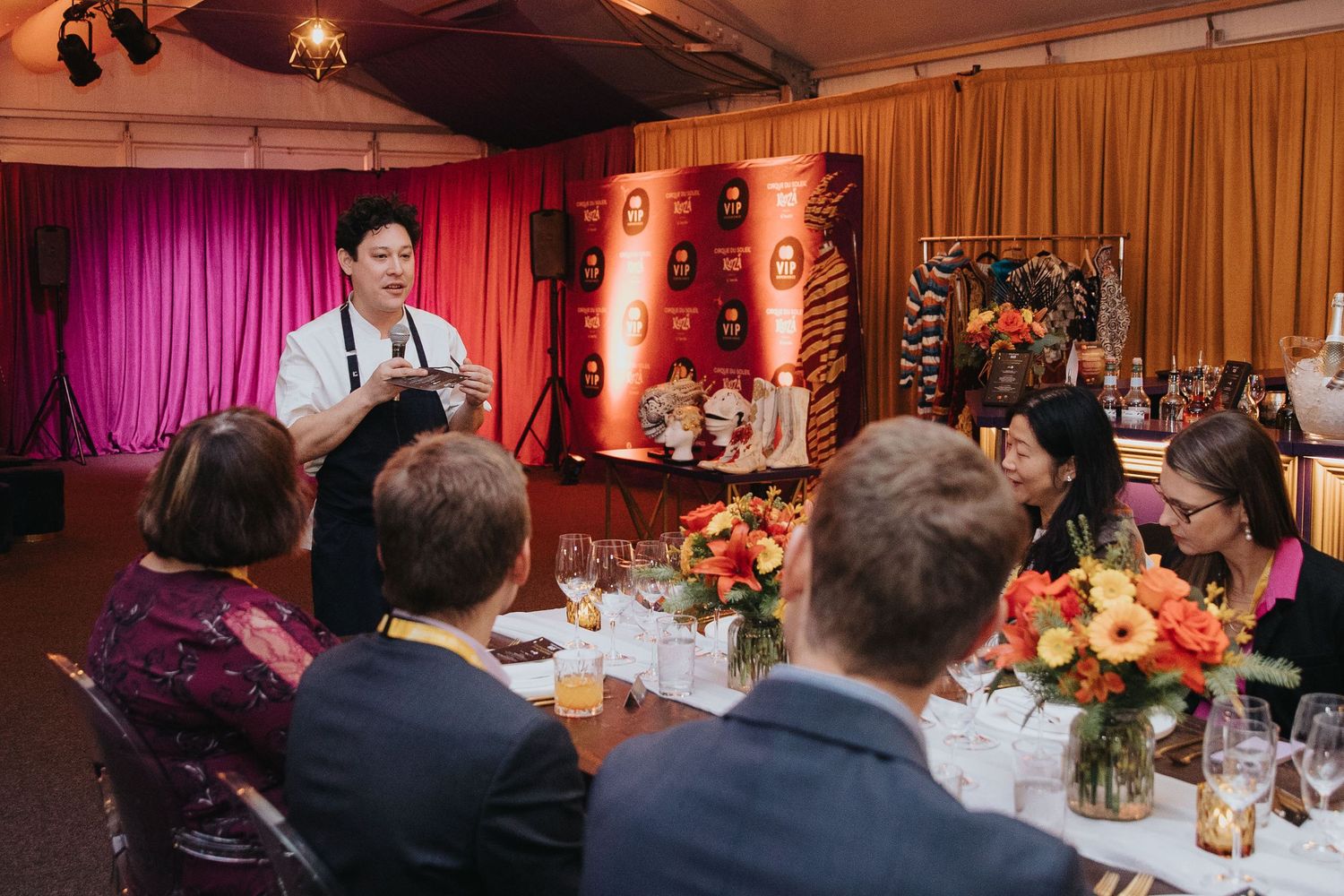 Elegant wedding reception dinner setup with floral centerpieces and warm lighting.