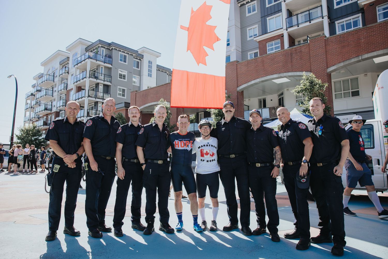 Group photo of uniformed personnel lined up at an outdoor event.