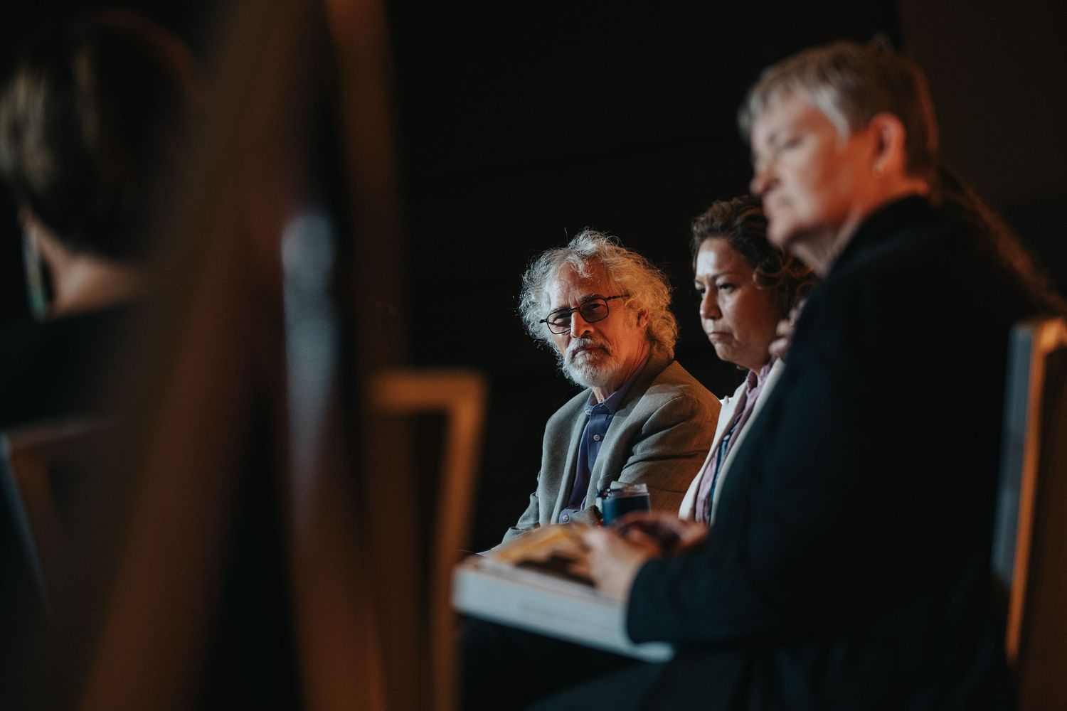 Conference attendees engaged in discussion during evening session.
