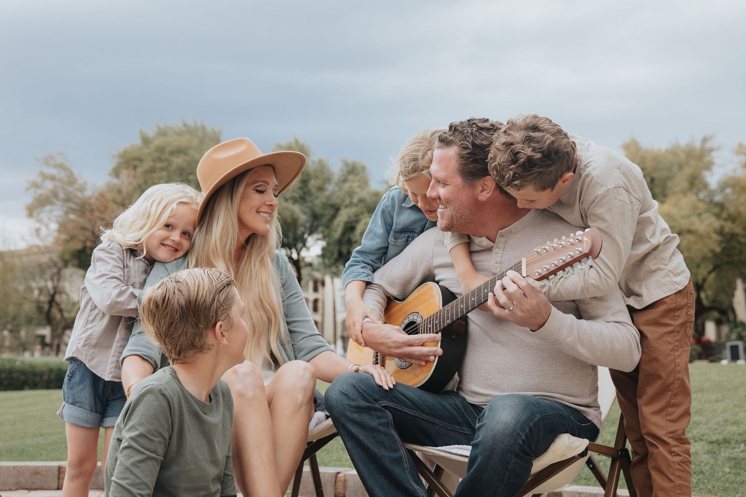 Heartwarming outdoor family moments shared on wooden chairs with musical instruments.