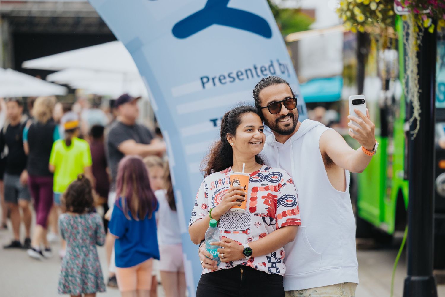 Festival attendees browsing vendor booths and displays at a community event.