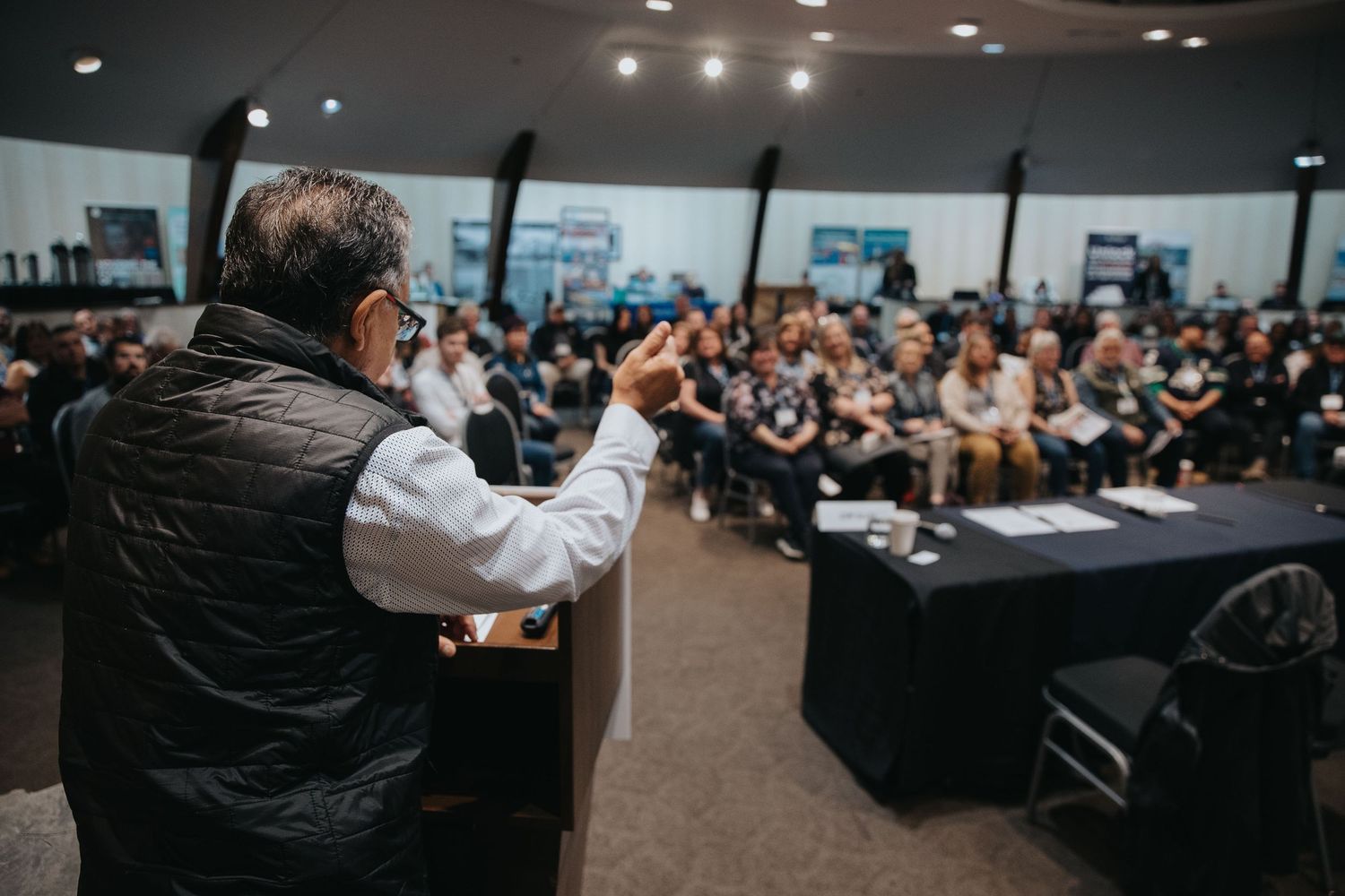 Large audience attending a corporate conference in a modern meeting room.