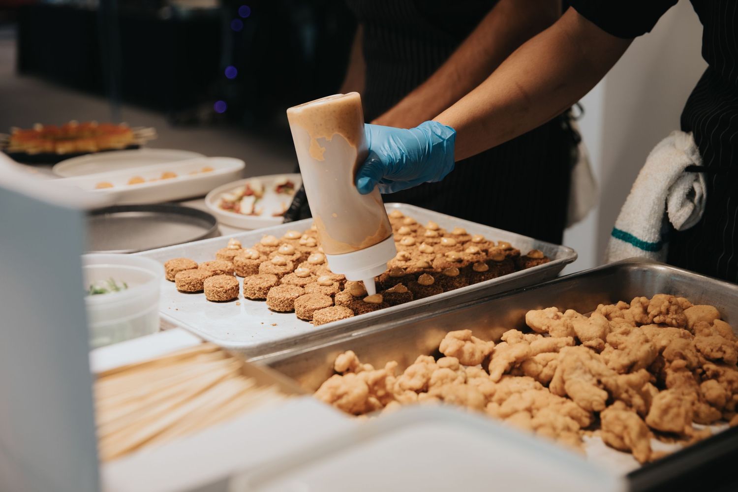 Fresh cookie dough being arranged on baking sheets for preparation.