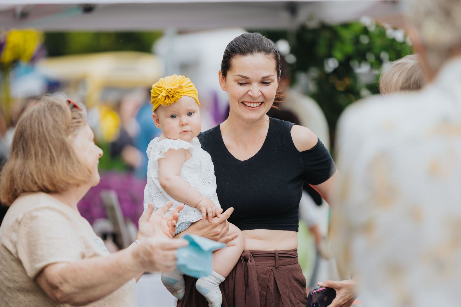 Parents and children enjoying activities at a family-friendly outdoor event.