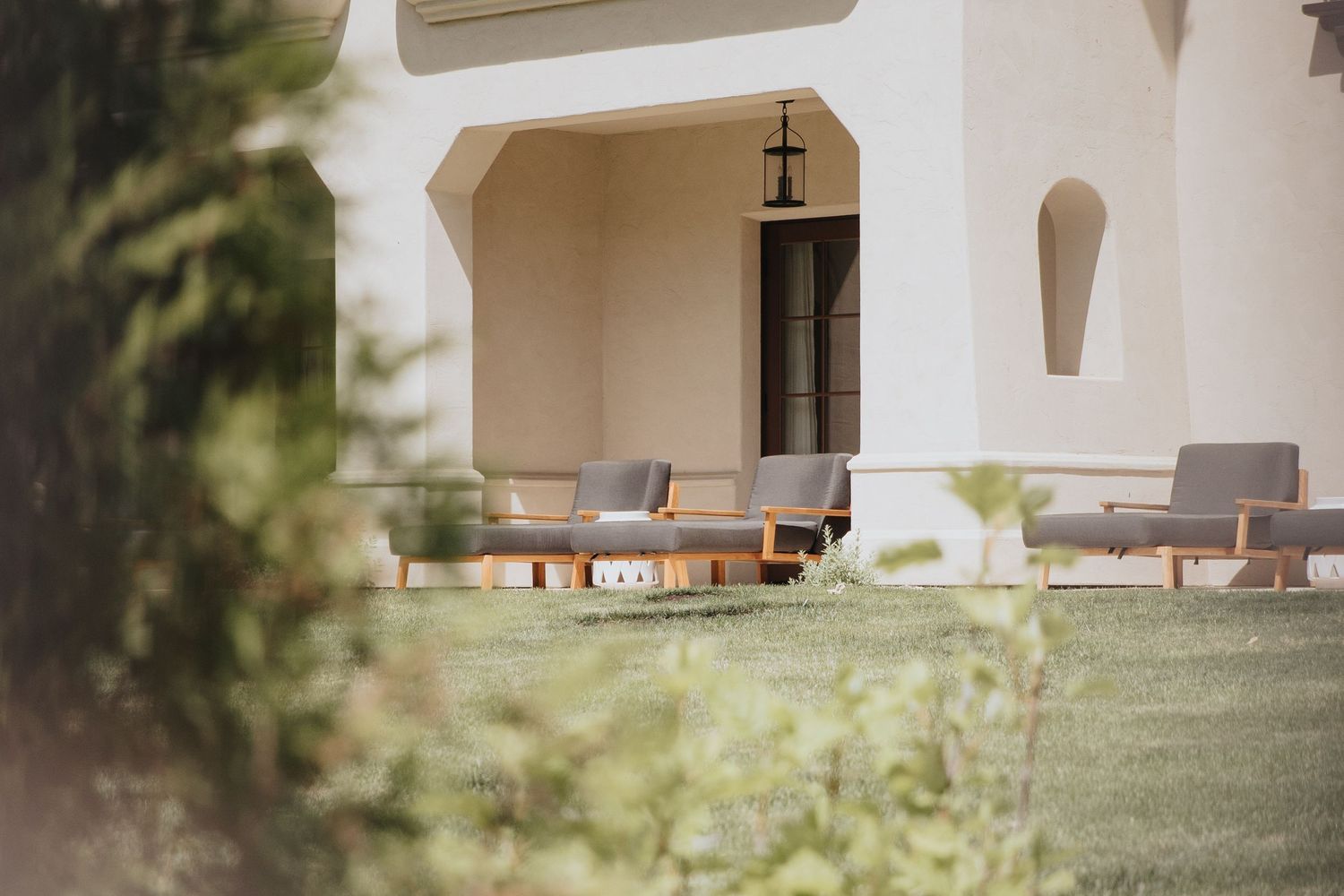 White stucco archways and columns of a Mediterranean-style building exterior.
