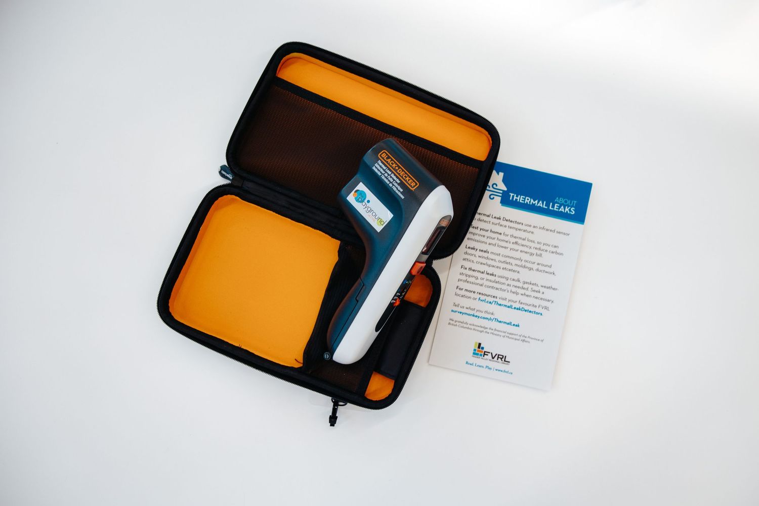 A collection of orange and black business card holders and cases displayed on a white background.