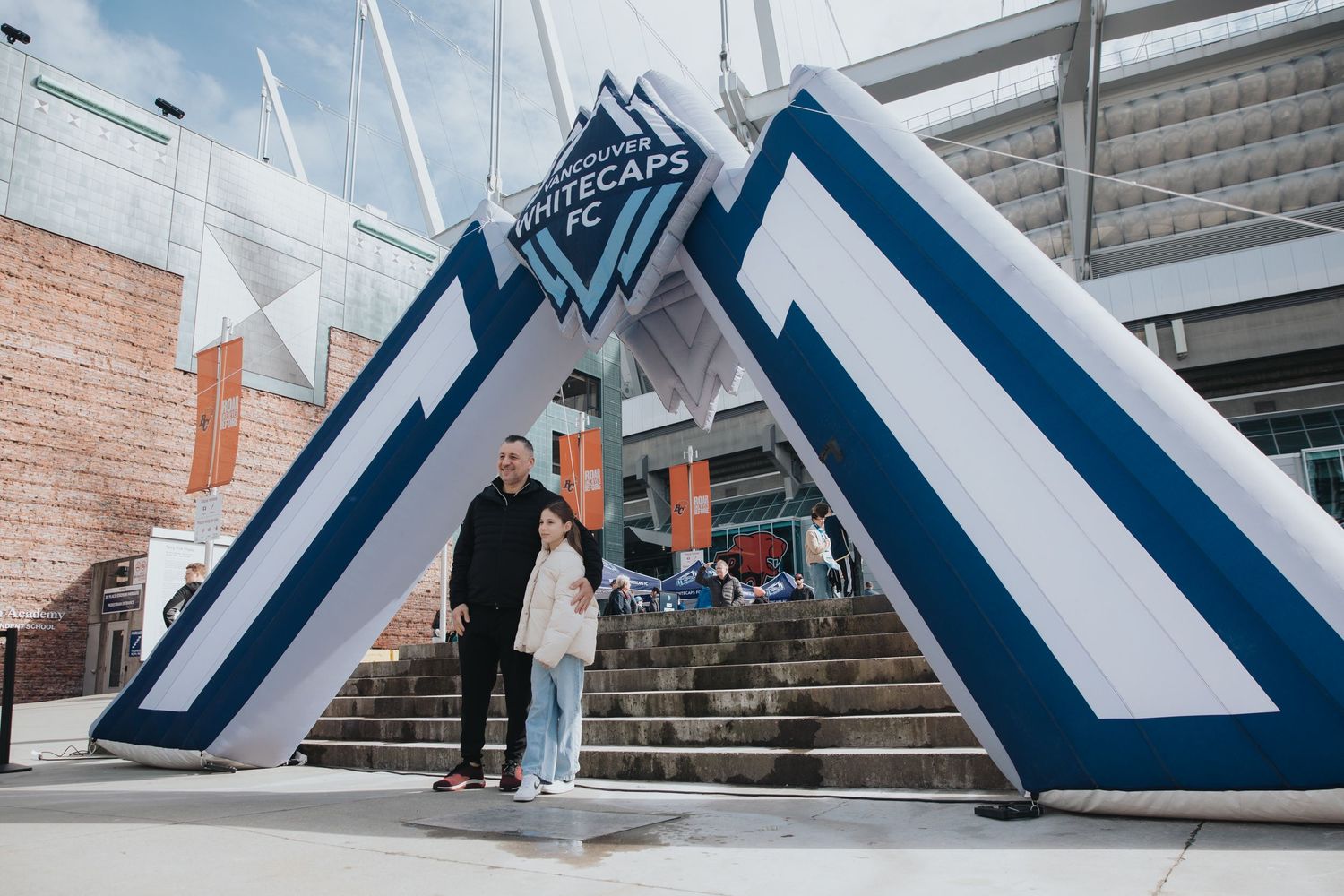 Modern esports venue exterior featuring geometric white and blue architectural elements.