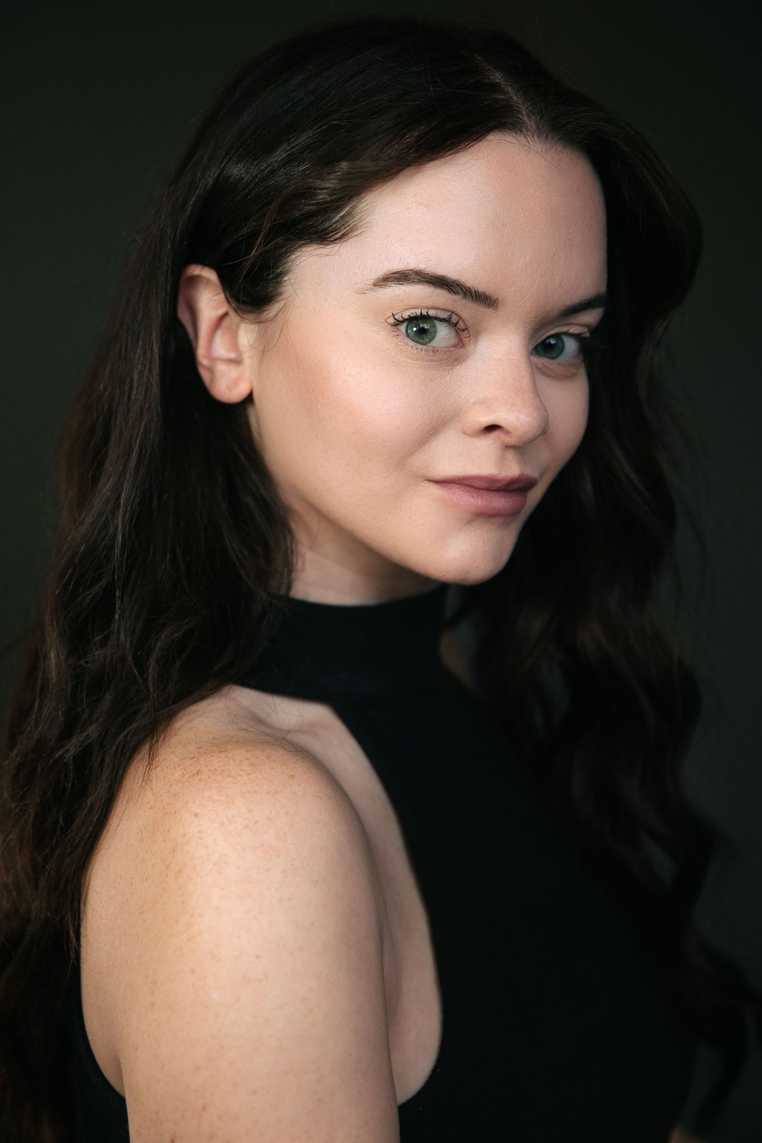 Portrait series showing different angles and poses against a dark background with dramatic lighting.