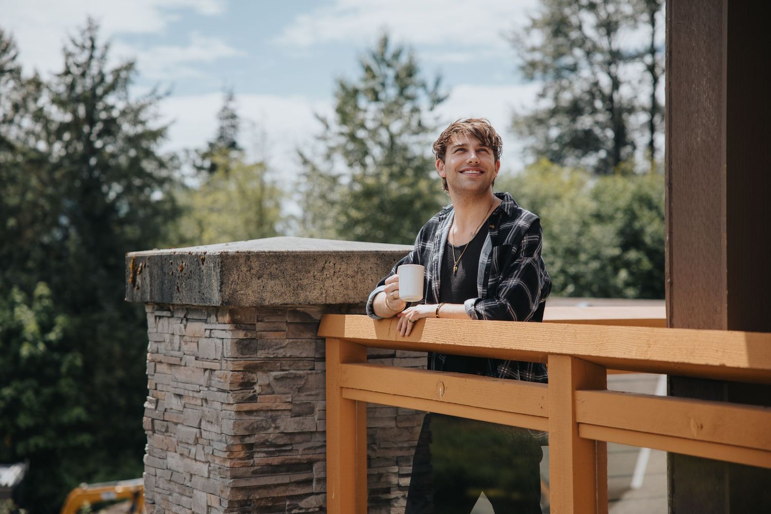 Stone and wood architectural details of mountain resort balcony with scenic backdrop.