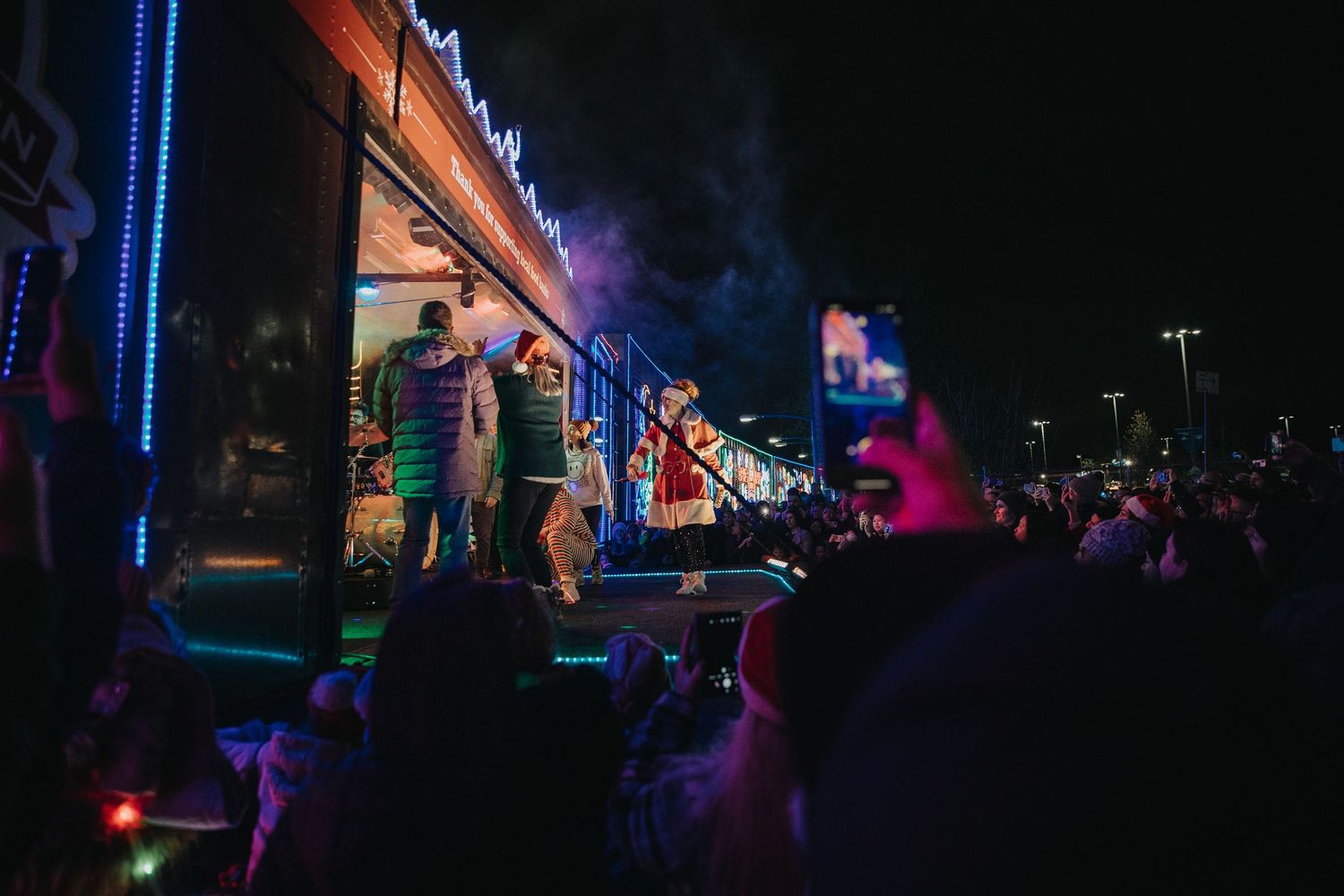 Nighttime outdoor concert venue with blue lighting and dark silhouettes.