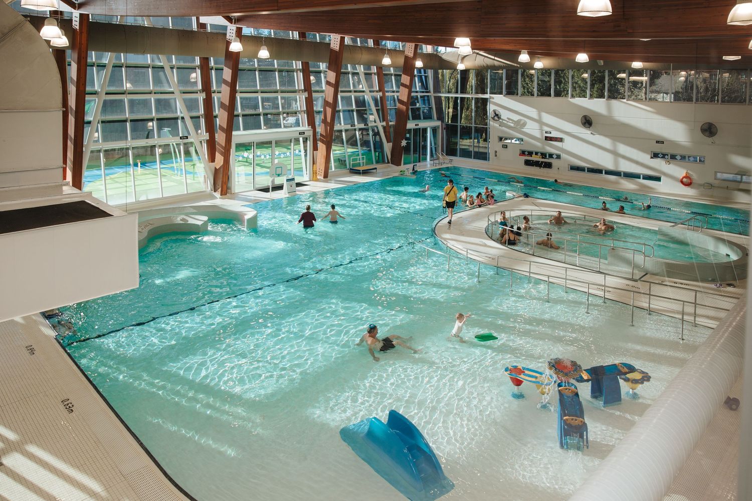 Large indoor swimming pool with multiple lanes and aquatic facilities.