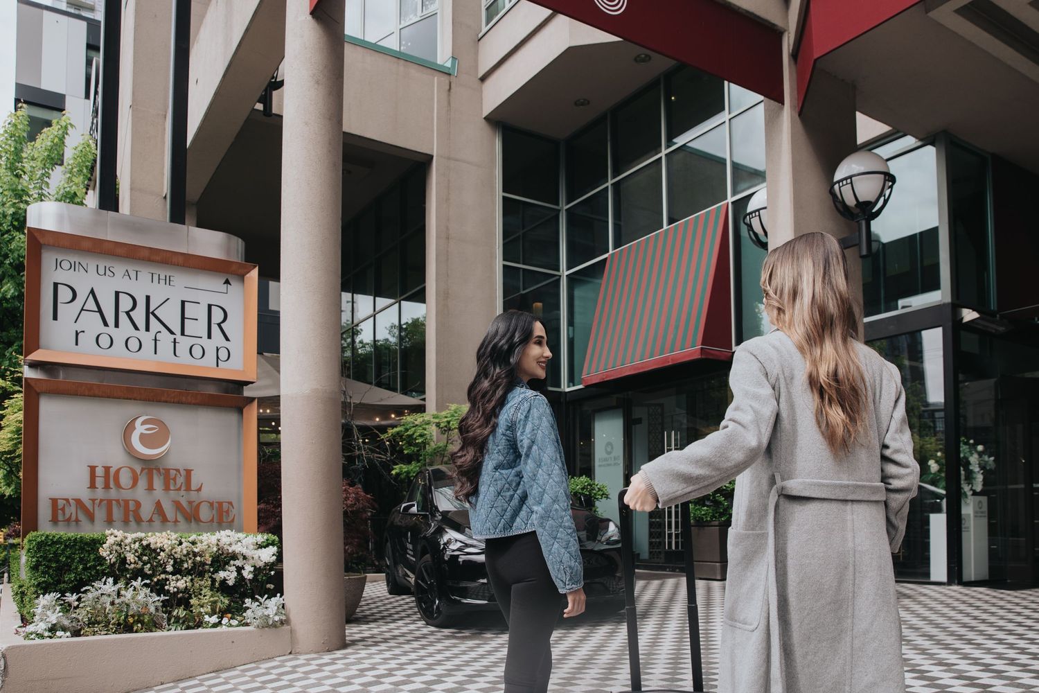 Entrance walkway to The Parker hotel with modern architectural columns and signage.