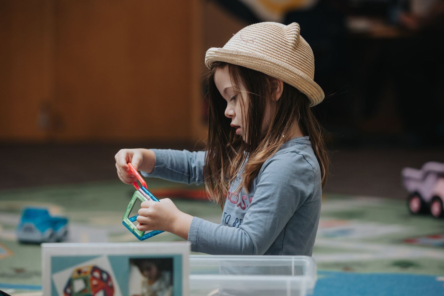 Children engaged in creative activities at a library table.