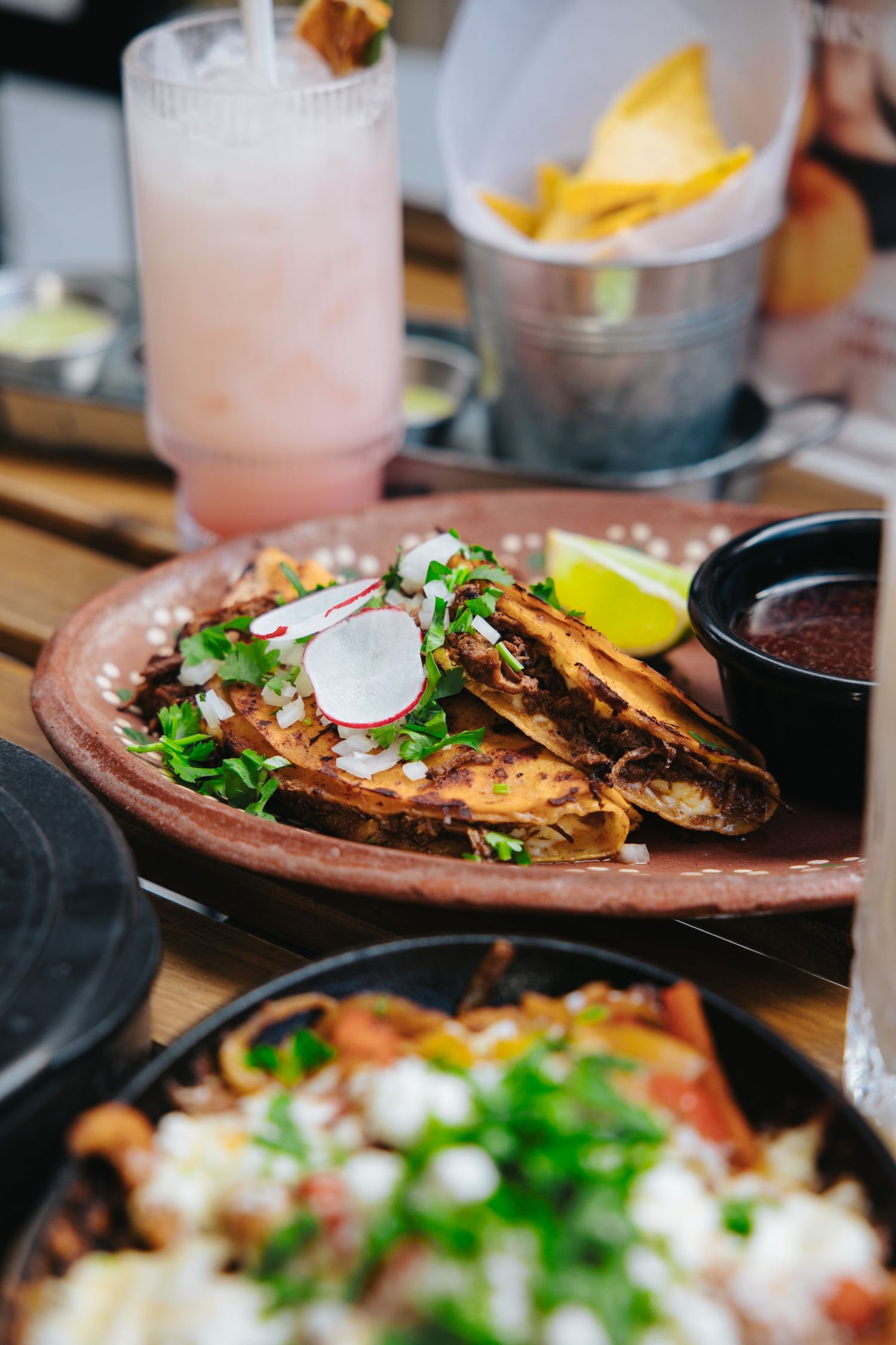 Plated dishes with garnished food in an upscale restaurant setting.