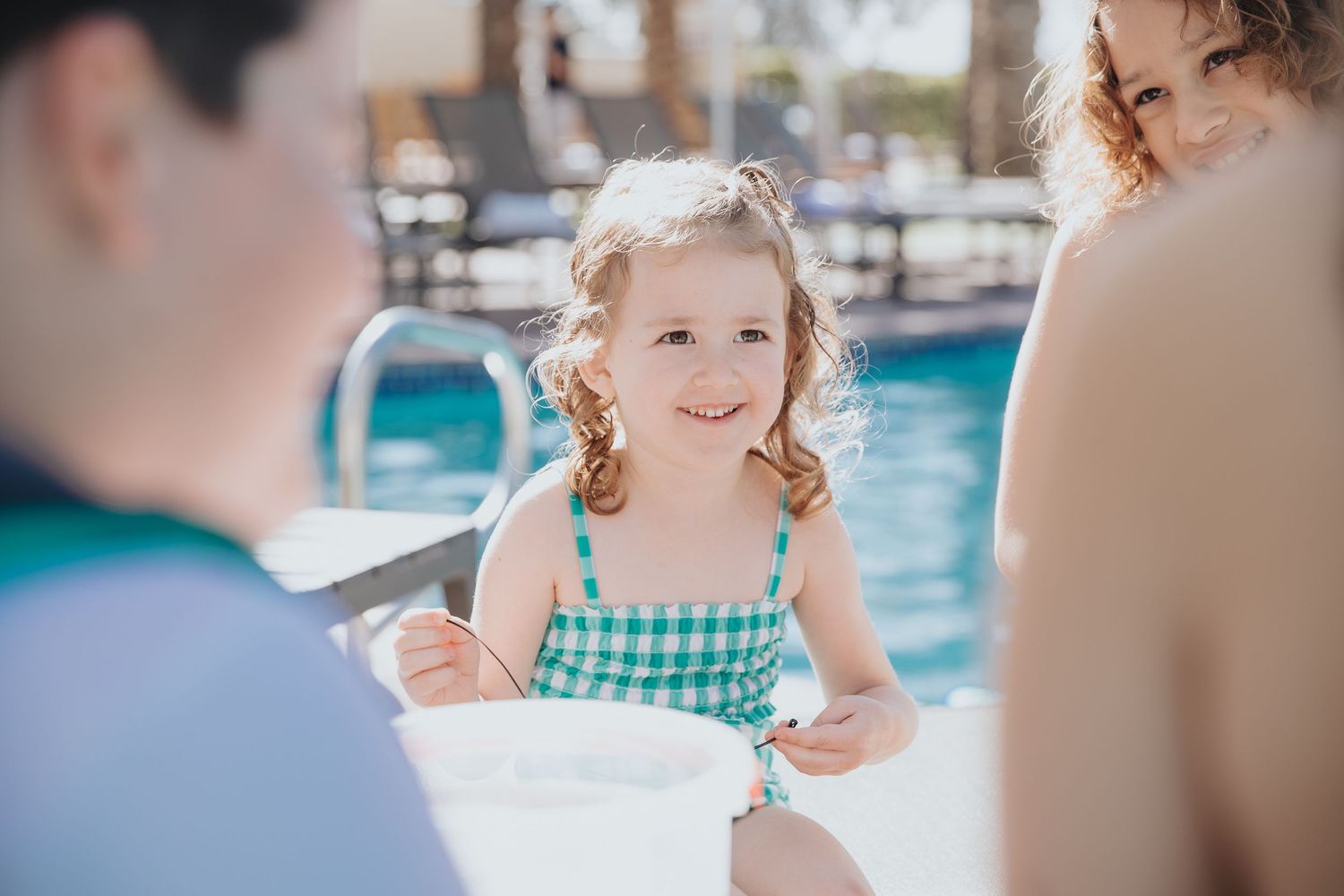 Joyful poolside moments captured at a luxury resort swimming pool.