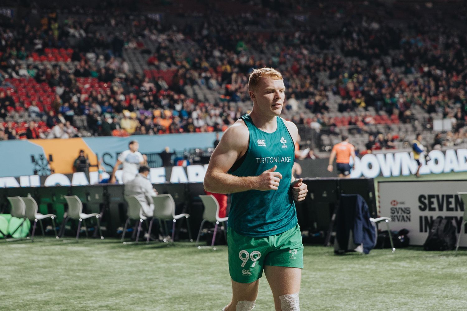 Rugby players lined up on field during professional match.