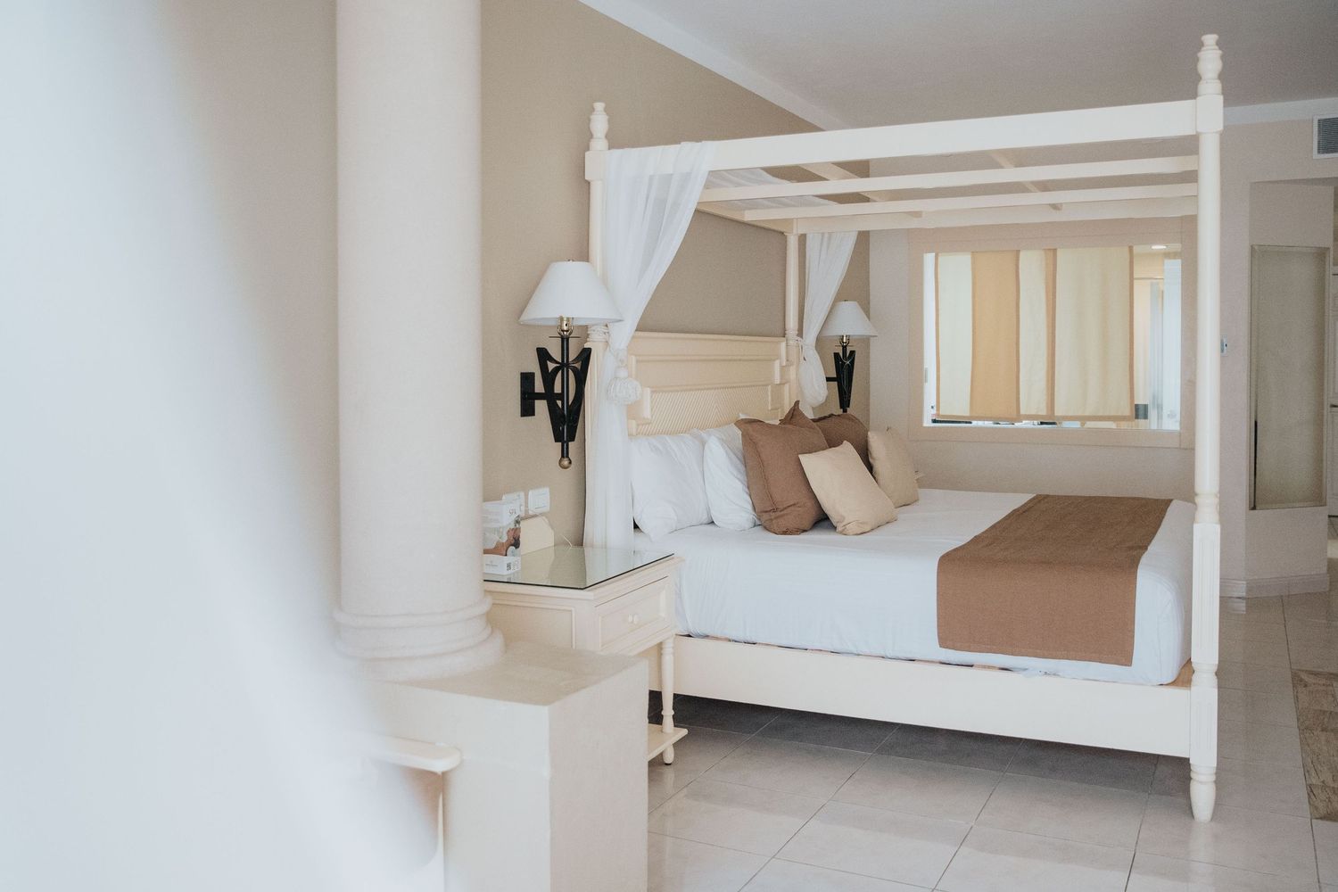 Bright white minimalist bedroom interior with clean modern furnishings.