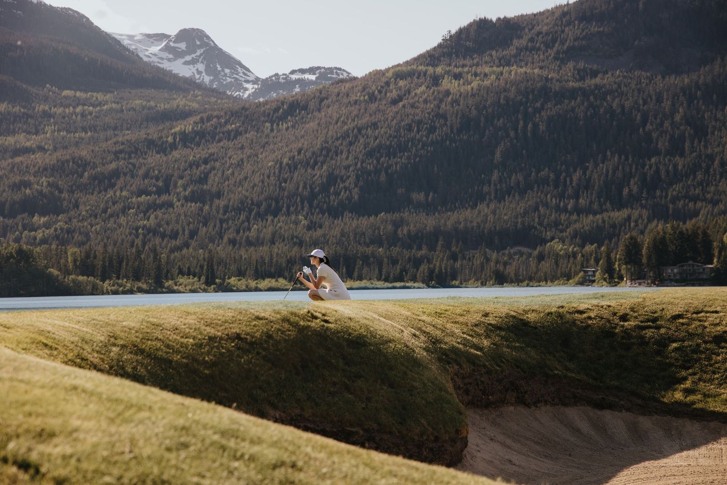 Snow-capped mountains and evergreen forests create a dramatic landscape vista.