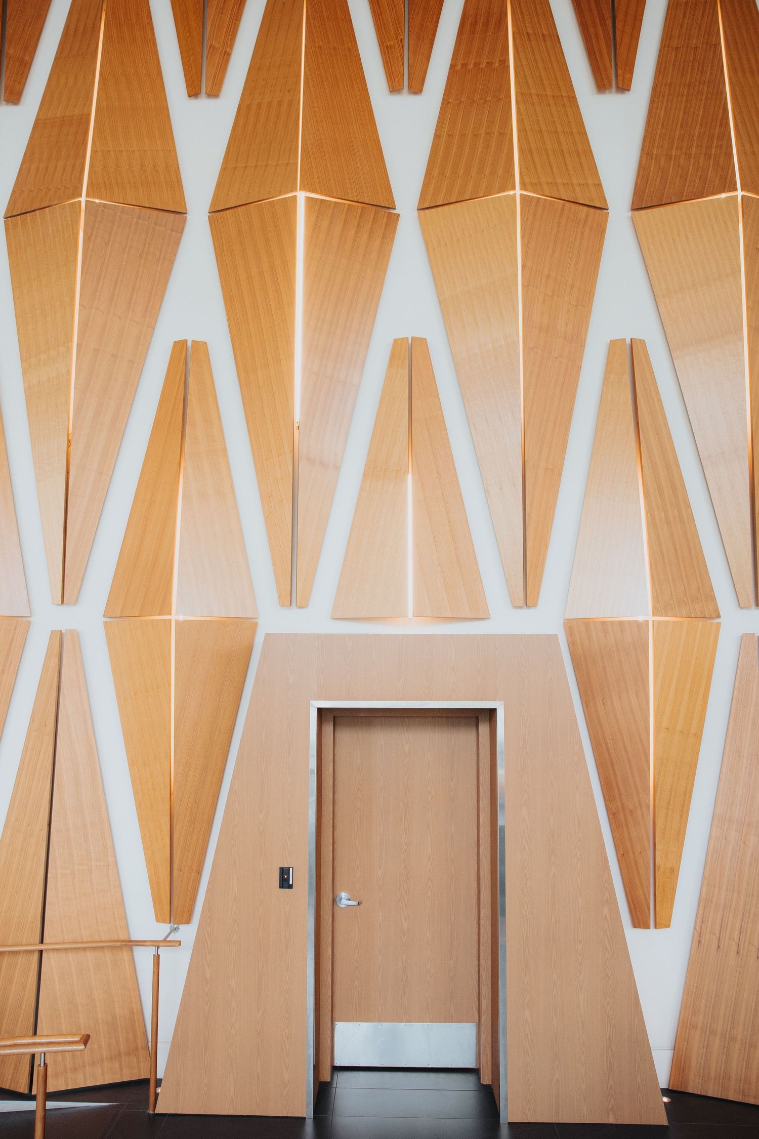 Decorative wooden wall panels with diamond patterns in a modern interior.