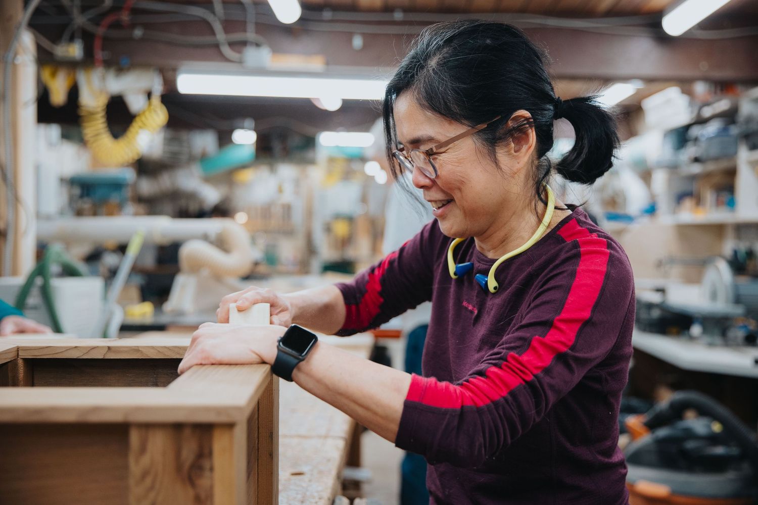People working in a craft workshop creating handmade items.