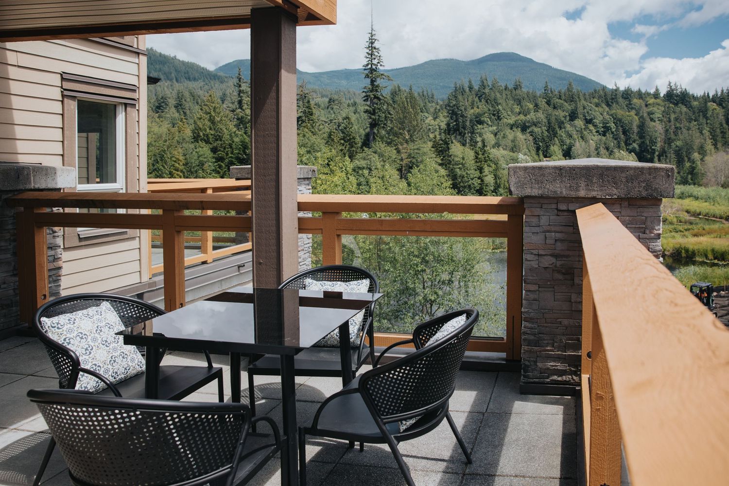 Spacious outdoor terrace with modern seating area and mountain views at luxury resort.