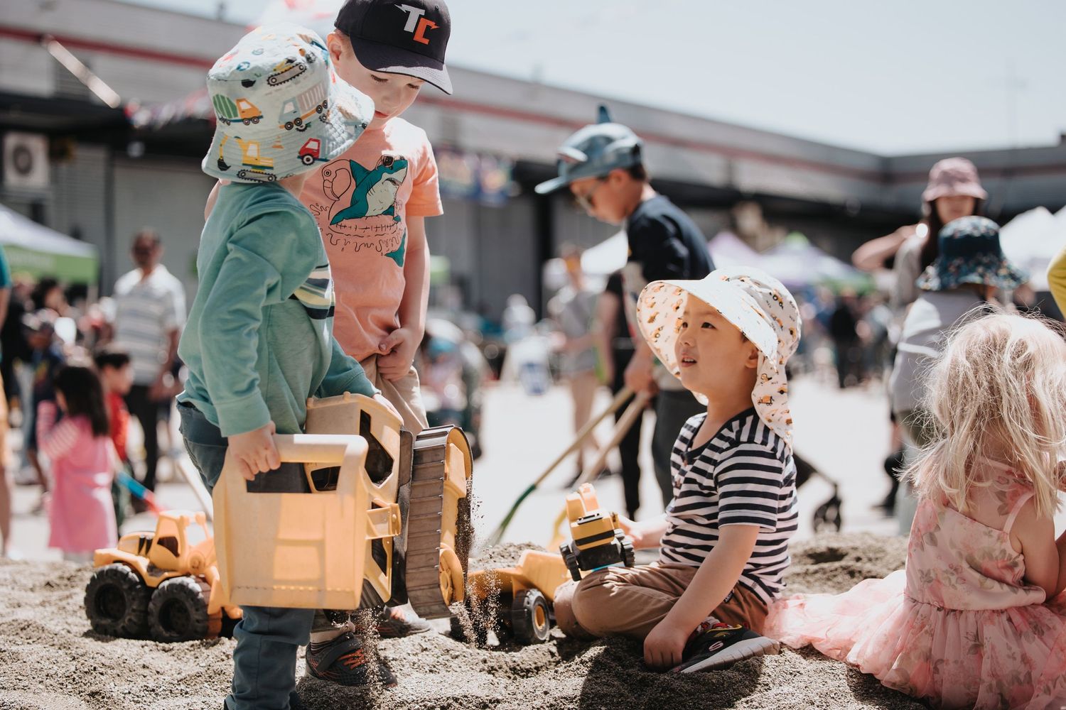 Children playing and engaging in activities at an outdoor community event.