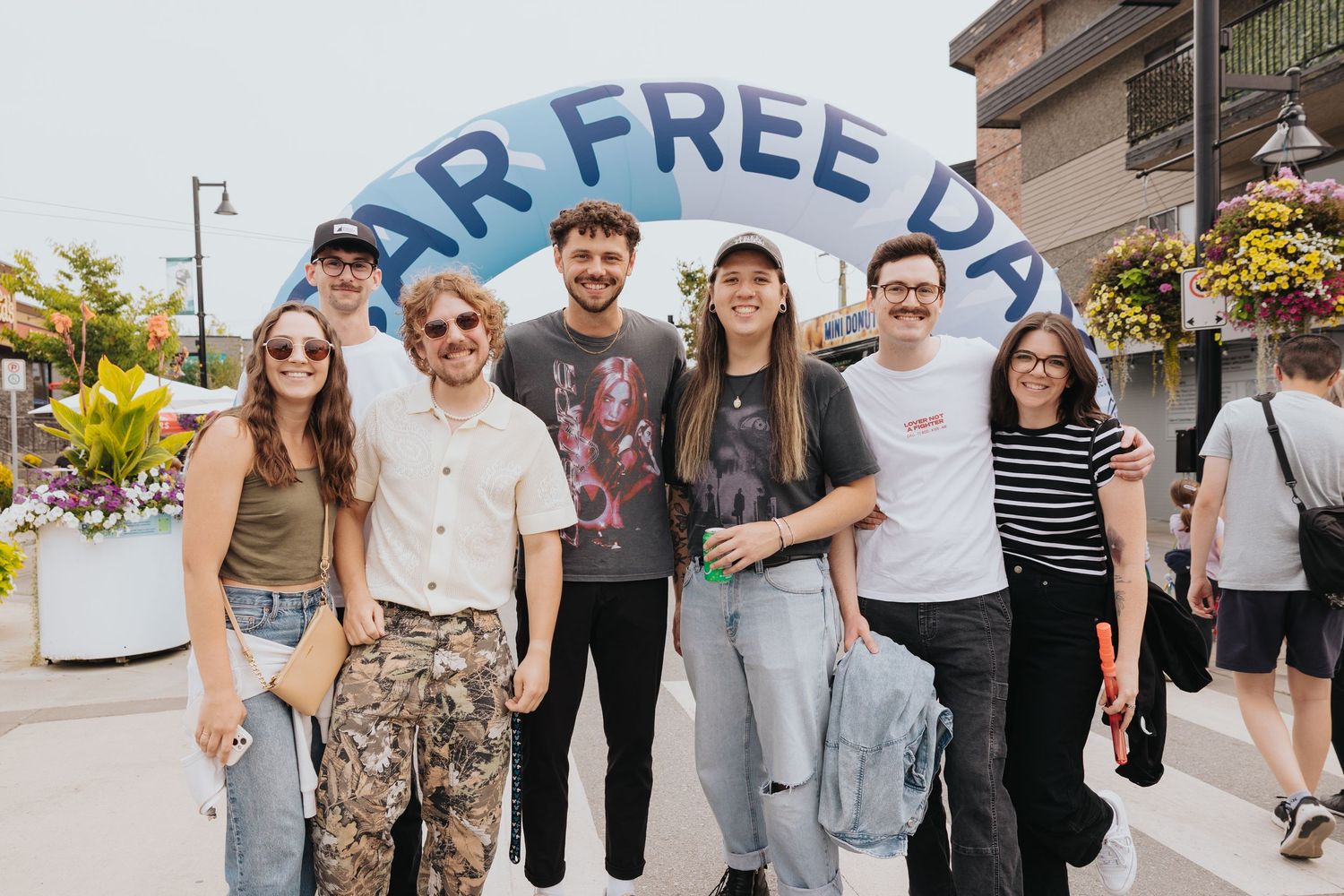 Attendees gathering under a 'Free Day' banner at a street festival.