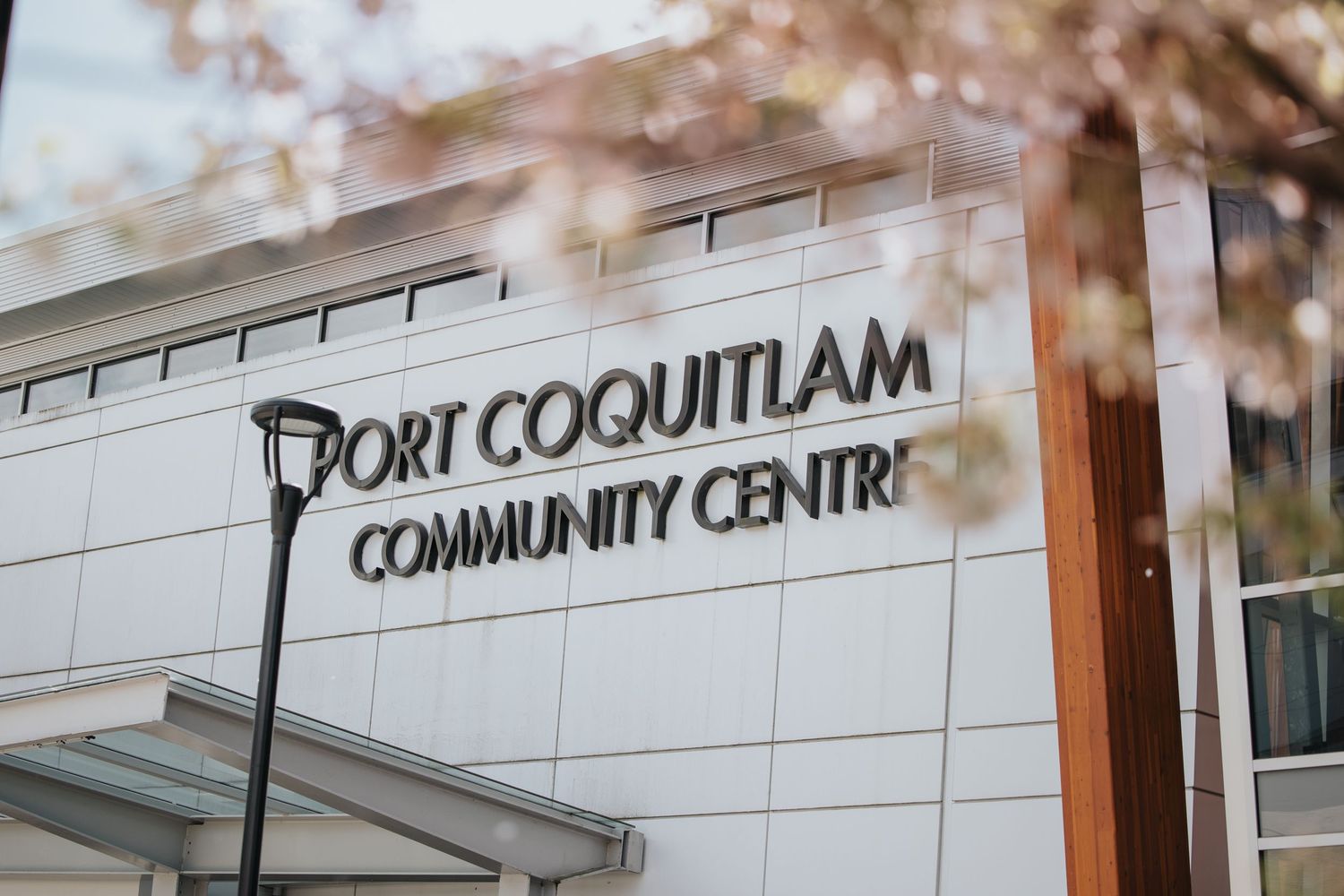 Port Coquitlam Community Centre sign on modern building exterior.