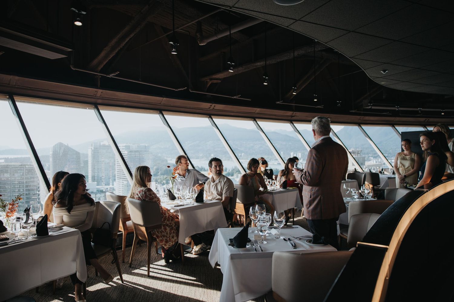 Panoramic view of an elegant dining room with floor-to-ceiling windows.