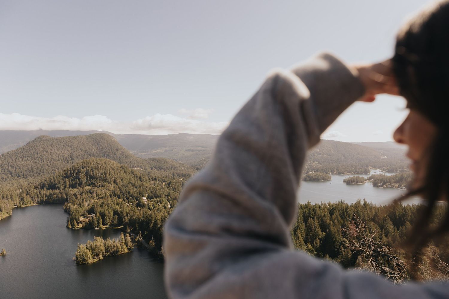 Scenic mountain lake view through evergreen forest on a cloudy day.