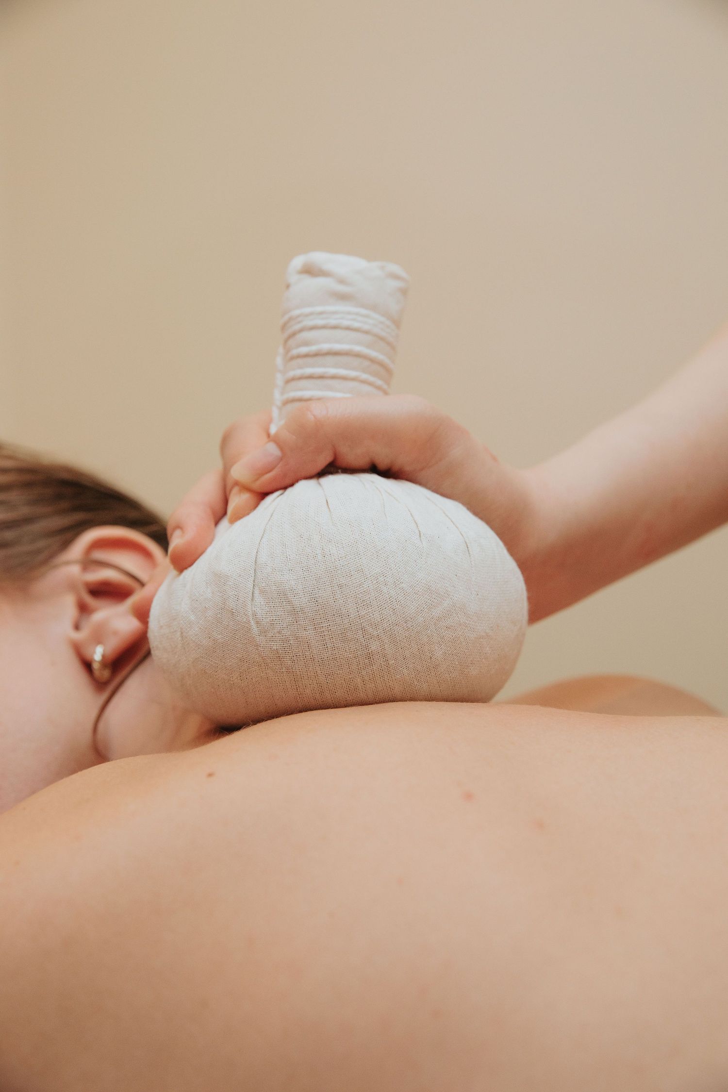 Close-up shots of hands performing a therapeutic massage treatment on a client.