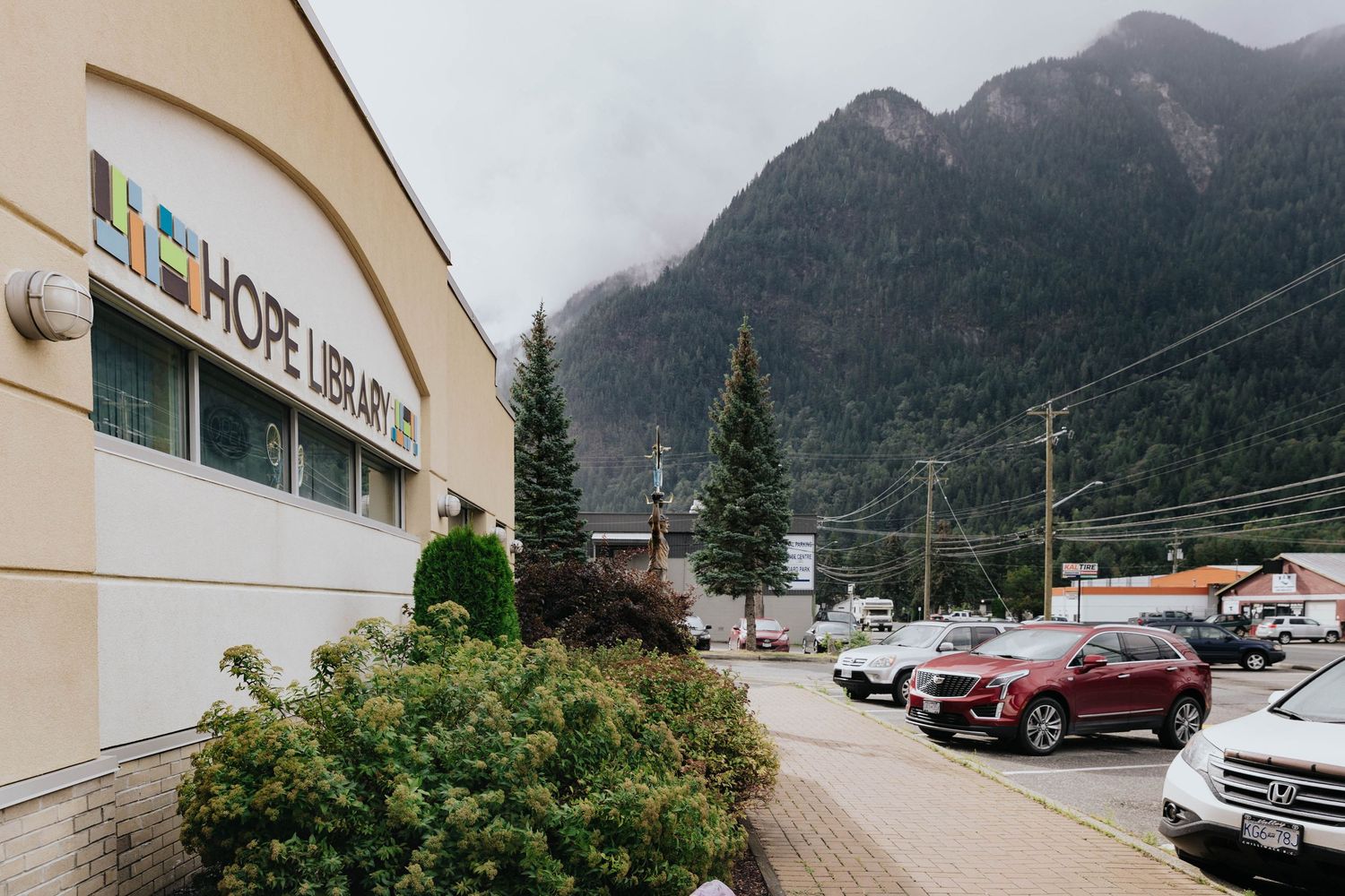 Exterior view of a library building with mountains visible in the background.