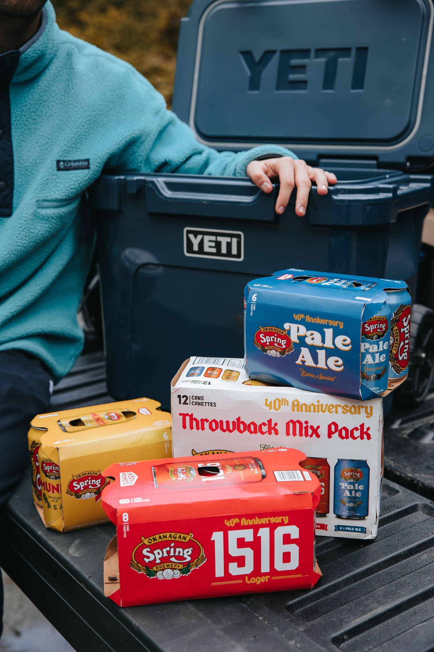 Spring Valley beer variety packs and boxes displayed on a Yeti cooler outdoors.