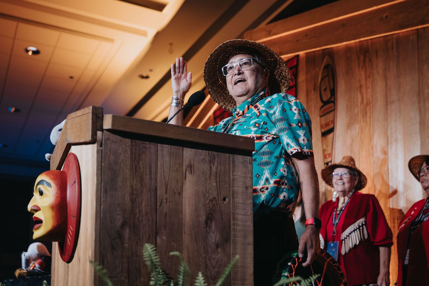 Energetic performers entertaining crowd in rustic wooden venue.