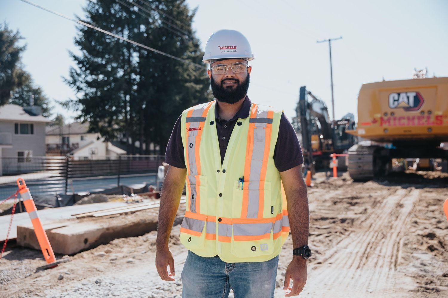 Construction workers in safety gear reviewing plans at a building site.