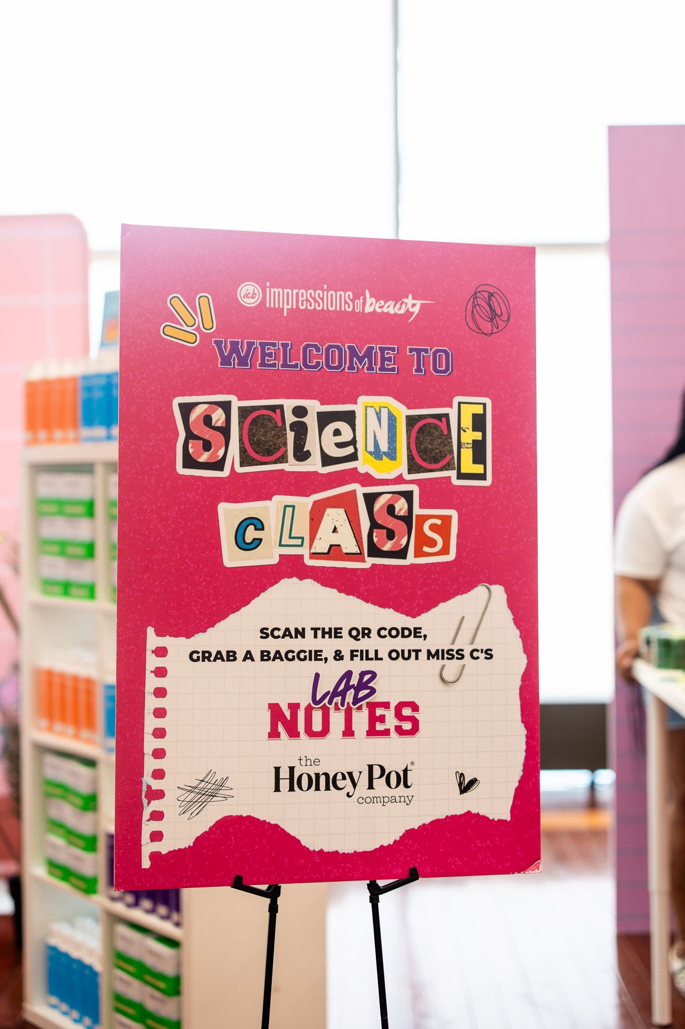 Pink welcome sign for Impressions of Beauty Science Class event featuring The Honey Pot Company lab notes activity.