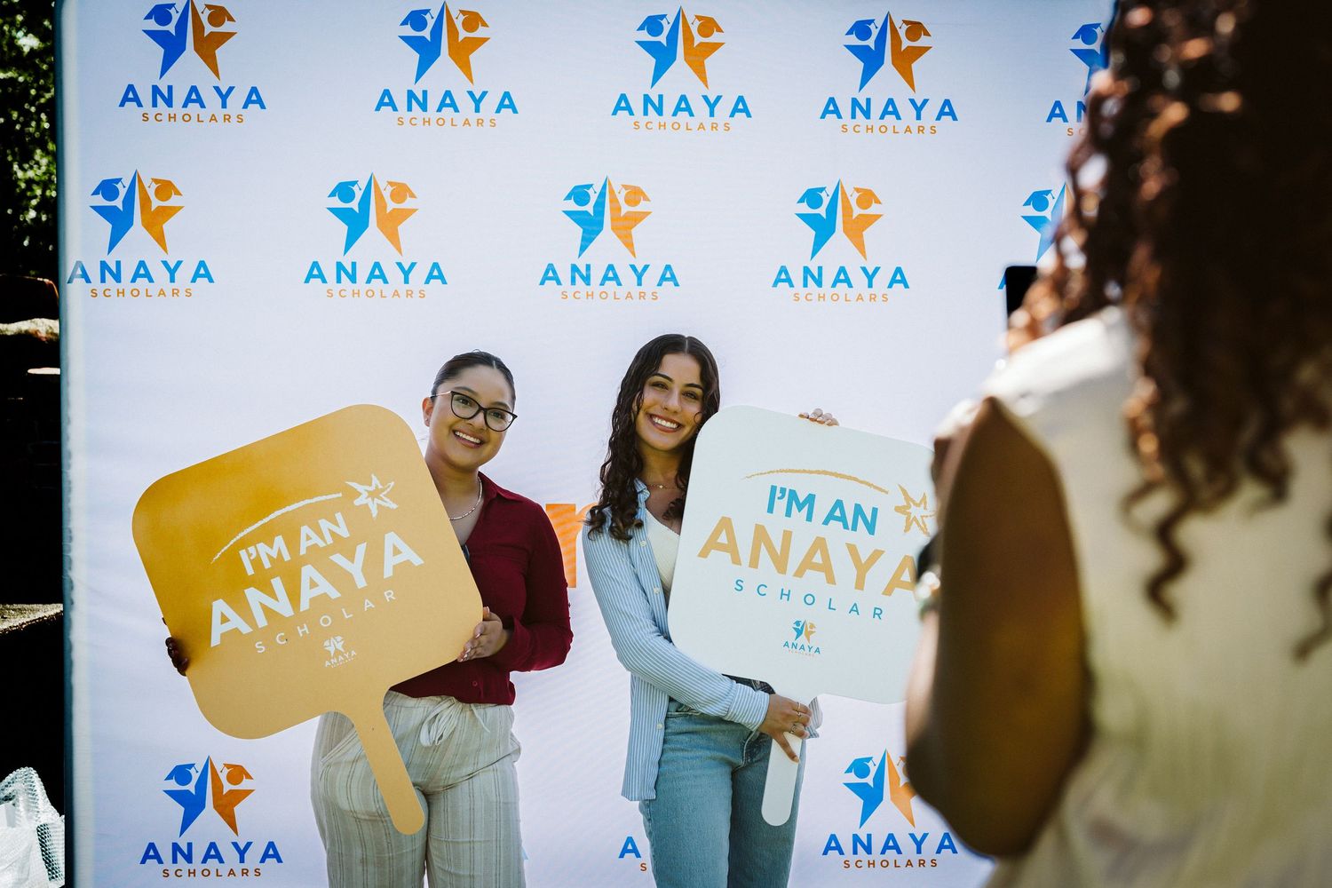 Event photos with branded backdrop showing Anaya company logo and signage.