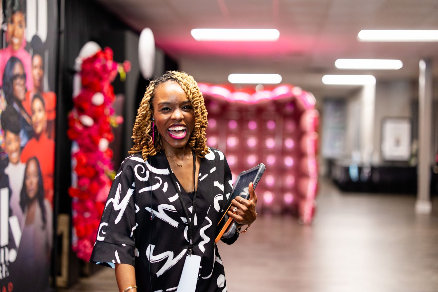 Person in black and white patterned outfit celebrating with joyful expression.