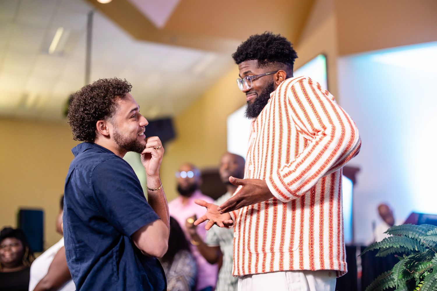 Two people sharing laughter and embracing in casual setting.