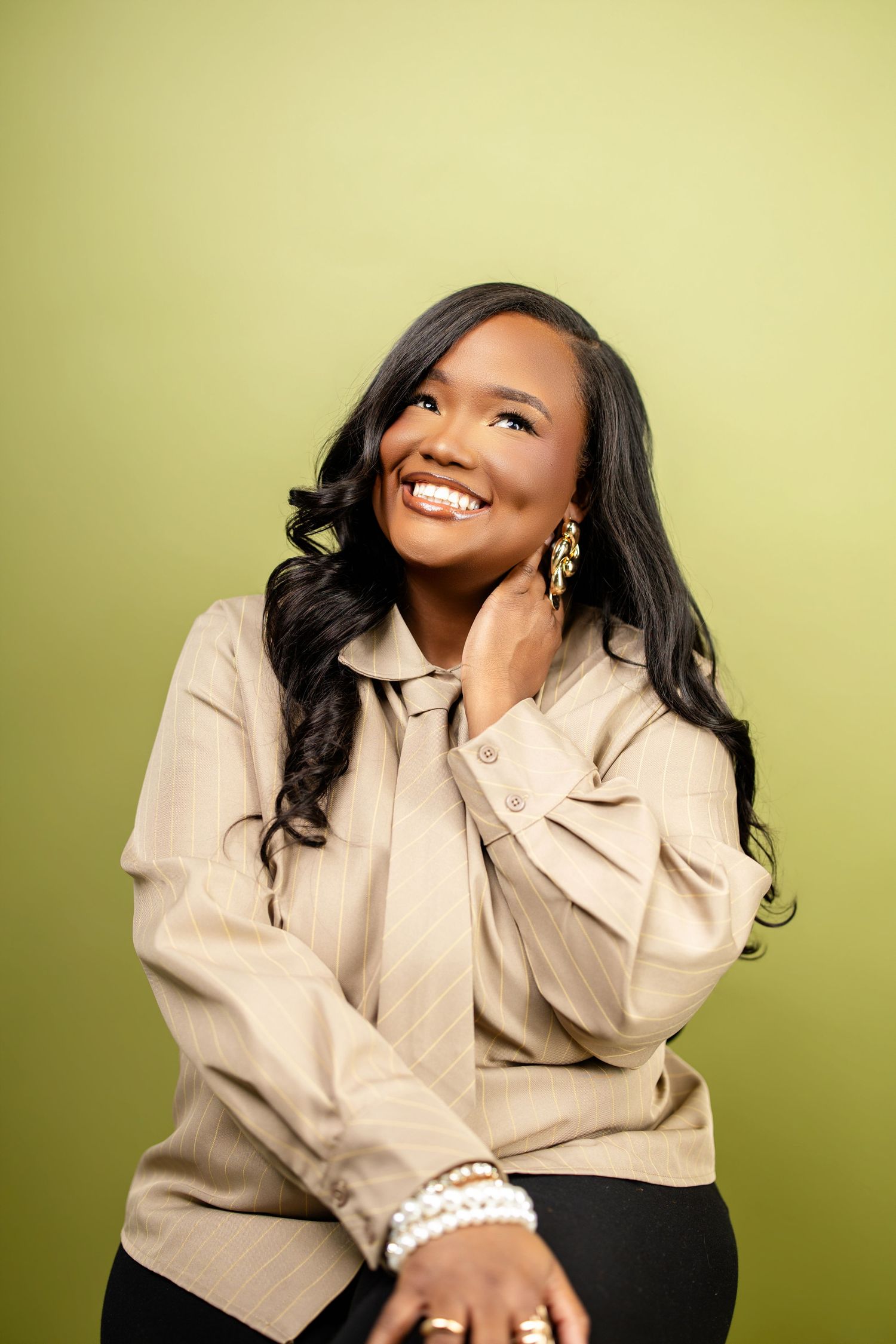 Professional portrait series showing joyful expressions and poses in a beige blouse against yellow background.