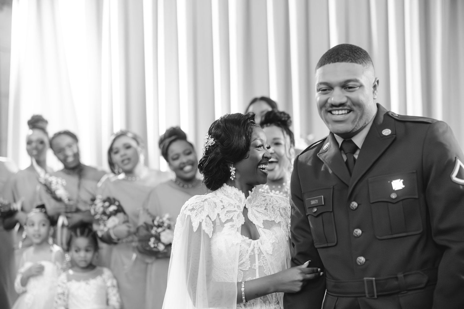 A group of people in uniform share joyful laughter together during a gathering.