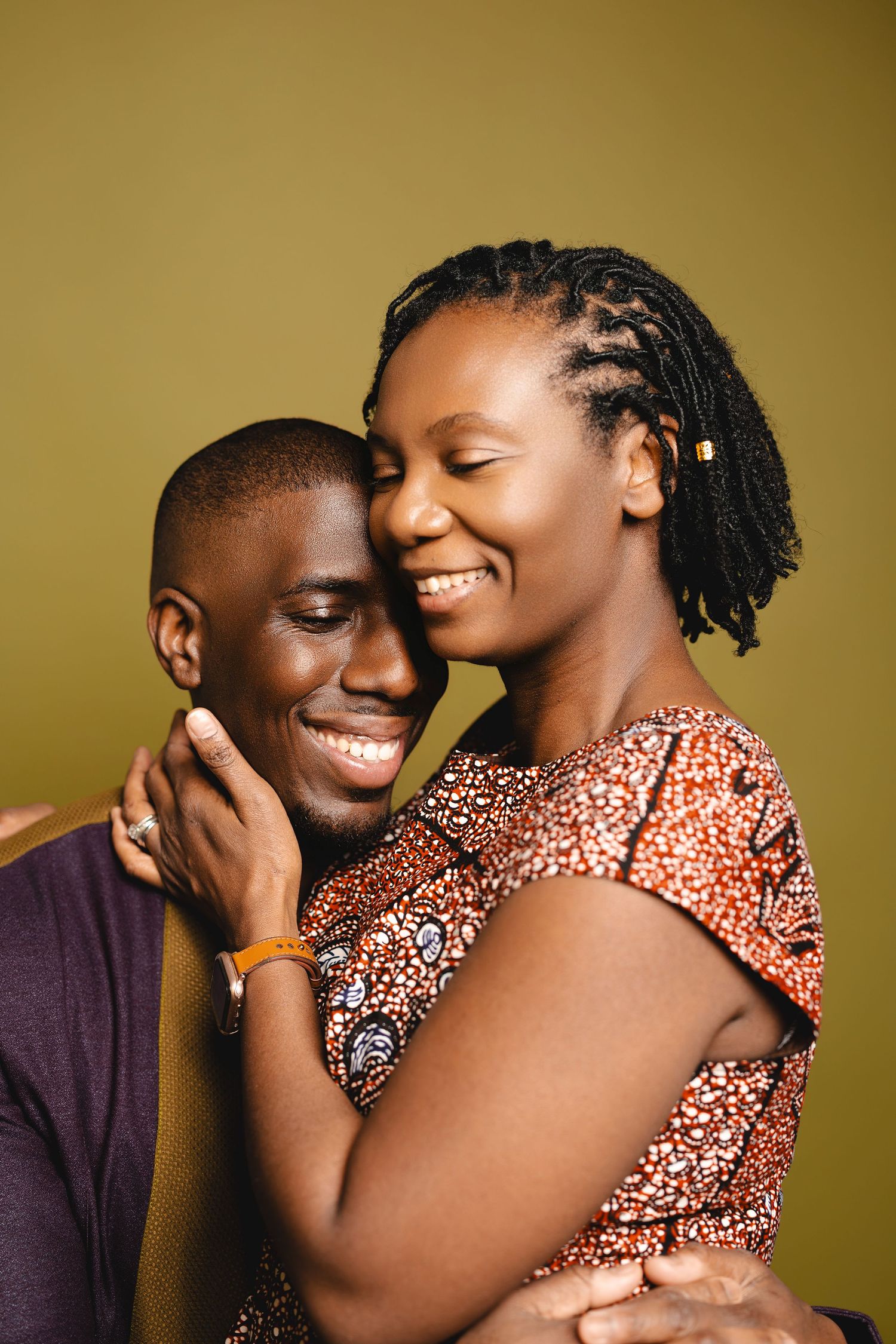 A romantic couple sharing intimate moments against a golden-brown backdrop.